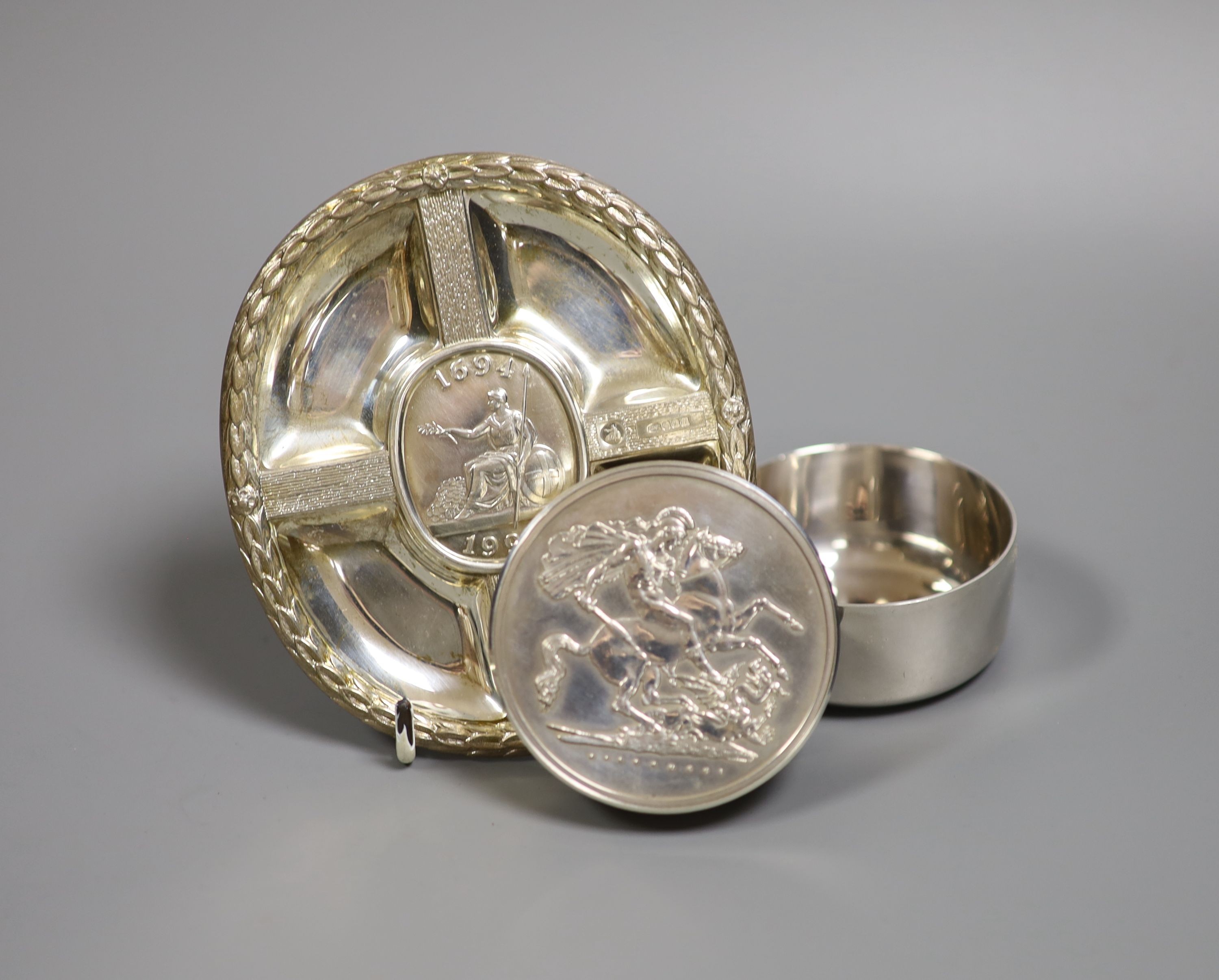 A modern silver pot and cover, decorated with St. George & The Dragon, diameter 61mm and a cased silver plaque, both by Christopher Nigel Lawrence.